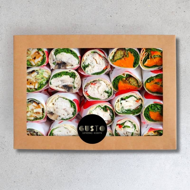 Box of assorted wrap sandwiches with a visible brand logo on a gray background