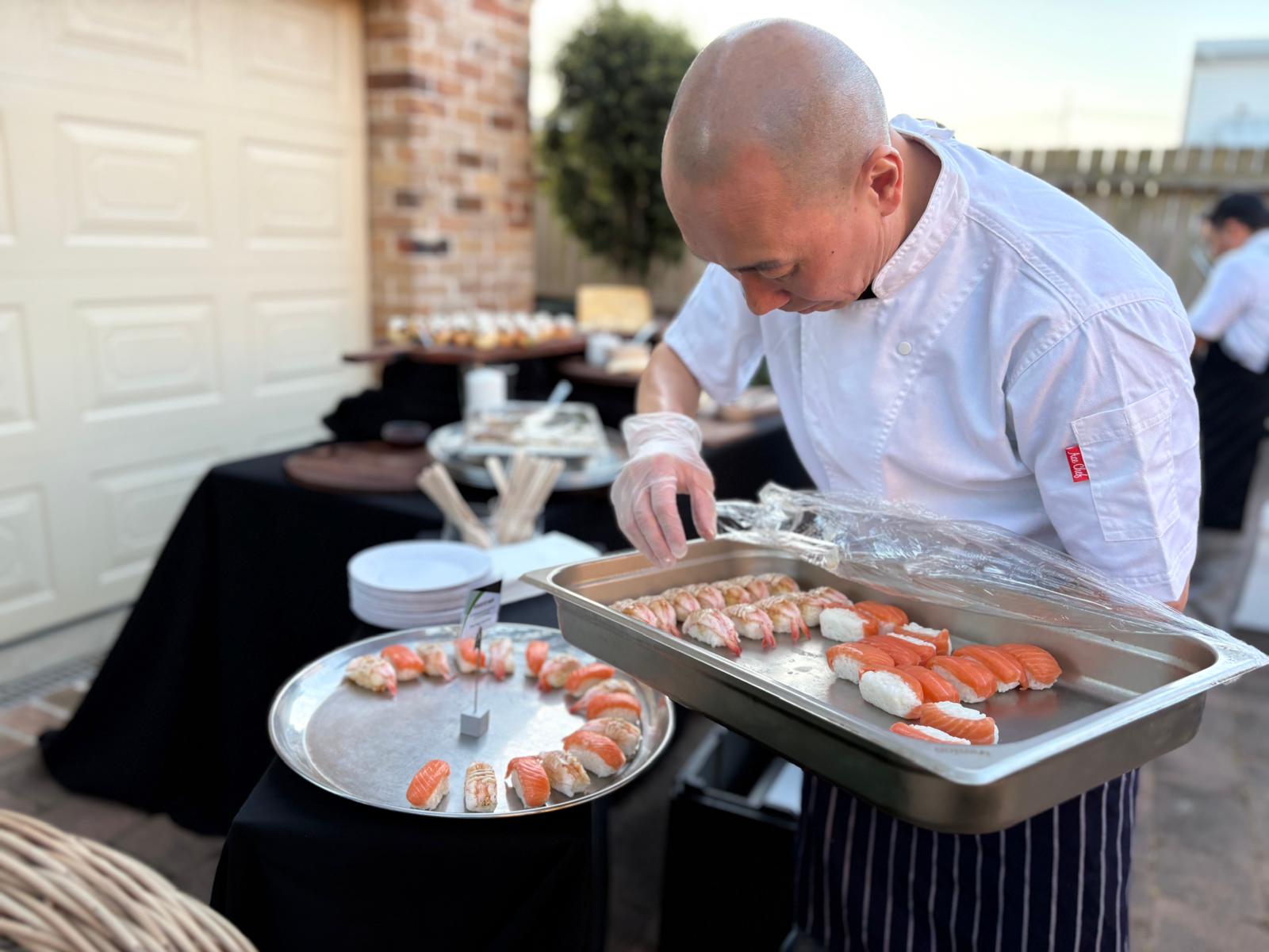 Chef preparing sushi at an outdoor event