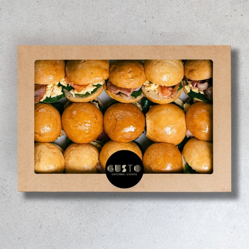 Box of mini sliders with a visible Gusto brand logo on a gray background