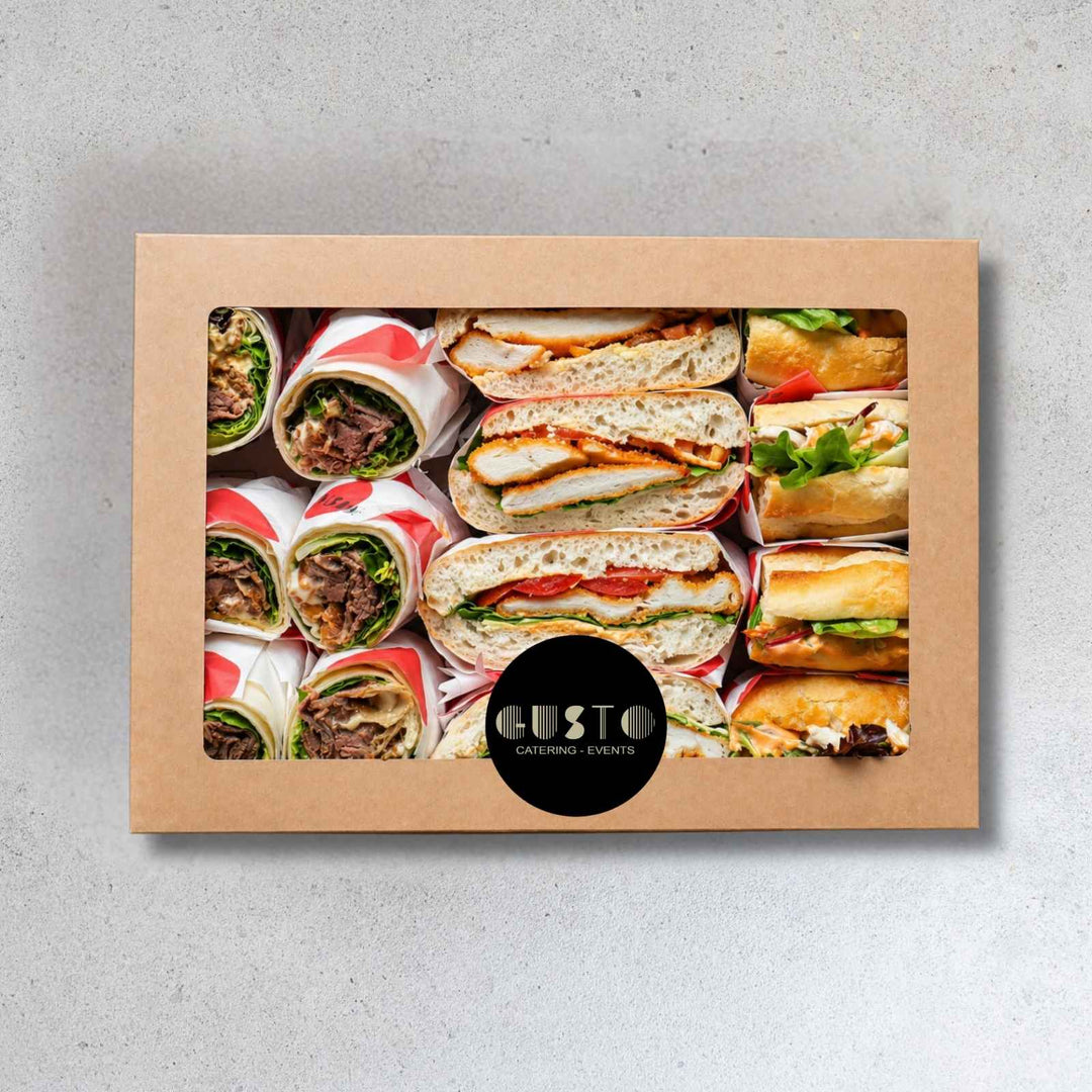 Cardboard box with images of sandwiches and wraps, featuring the Gusto Catering & Events logo.