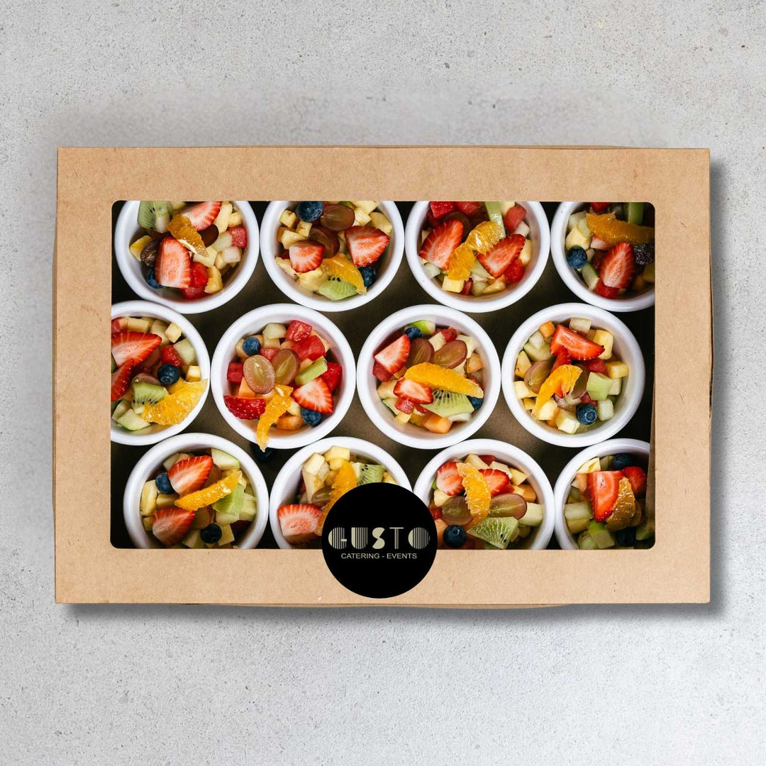 Box of assorted fruit cups from Cafe Bustelo on a gray background