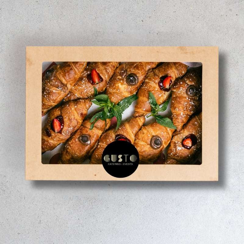 Box of pastries with a 'Gusto' logo on a gray background