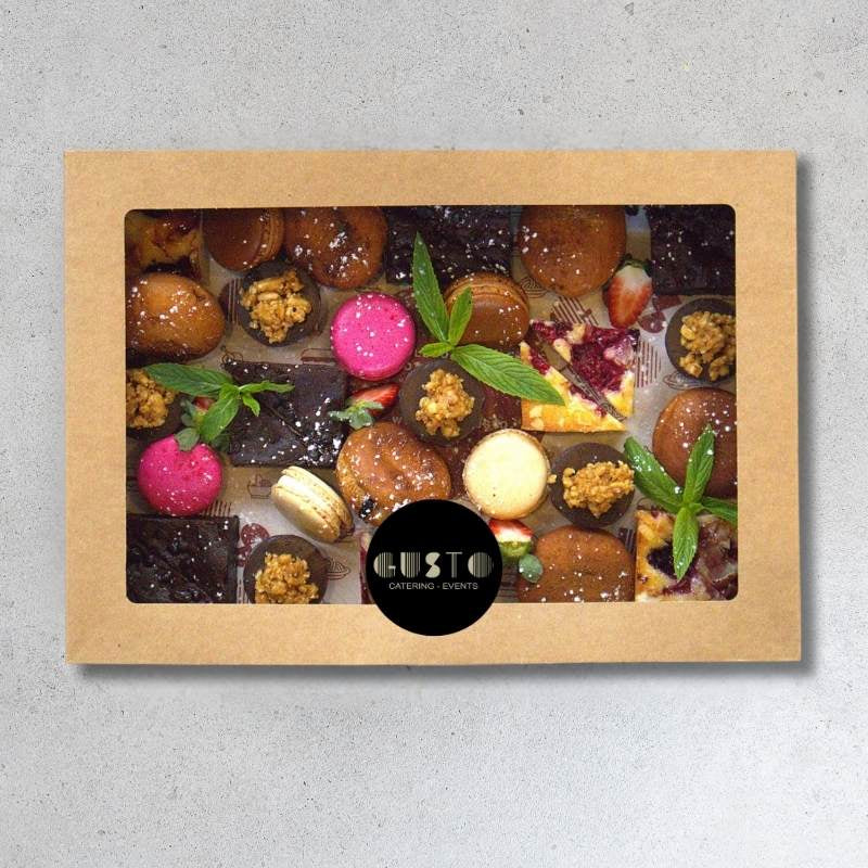 Box of assorted chocolates with a visible brand logo on a gray background