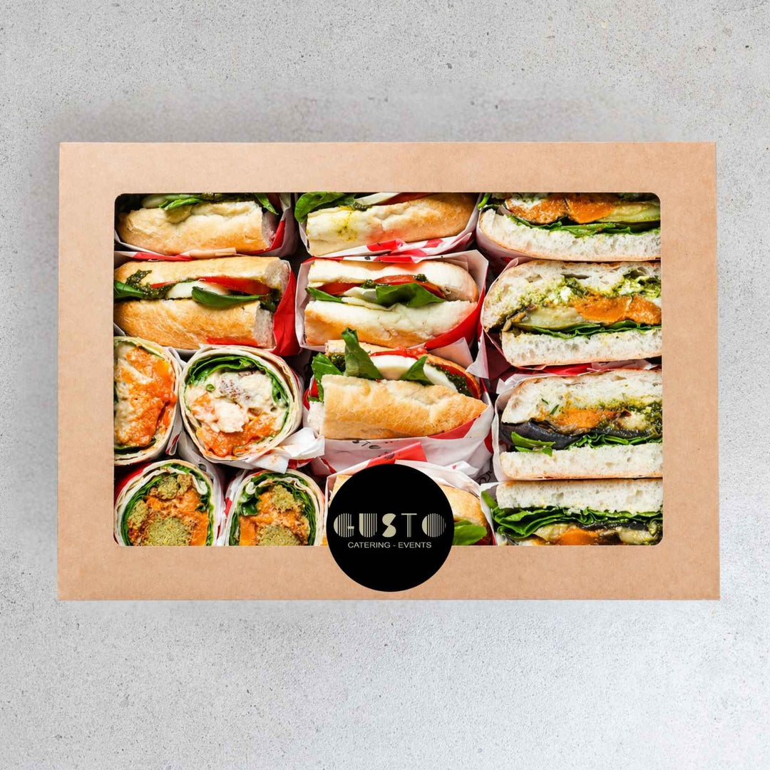 Box of assorted sandwiches with 'Gusto' branding on a gray background