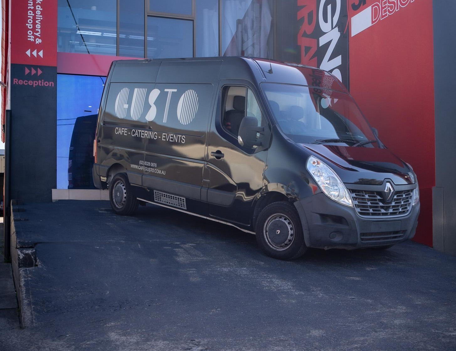 Van parked in front of a building with 'smilee SIGNS + WRAPS' branding.